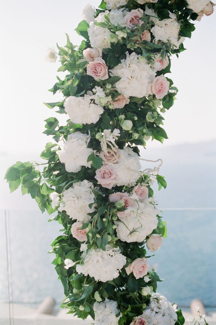 Ceremony arch with roses at Cavo Ventus wedding